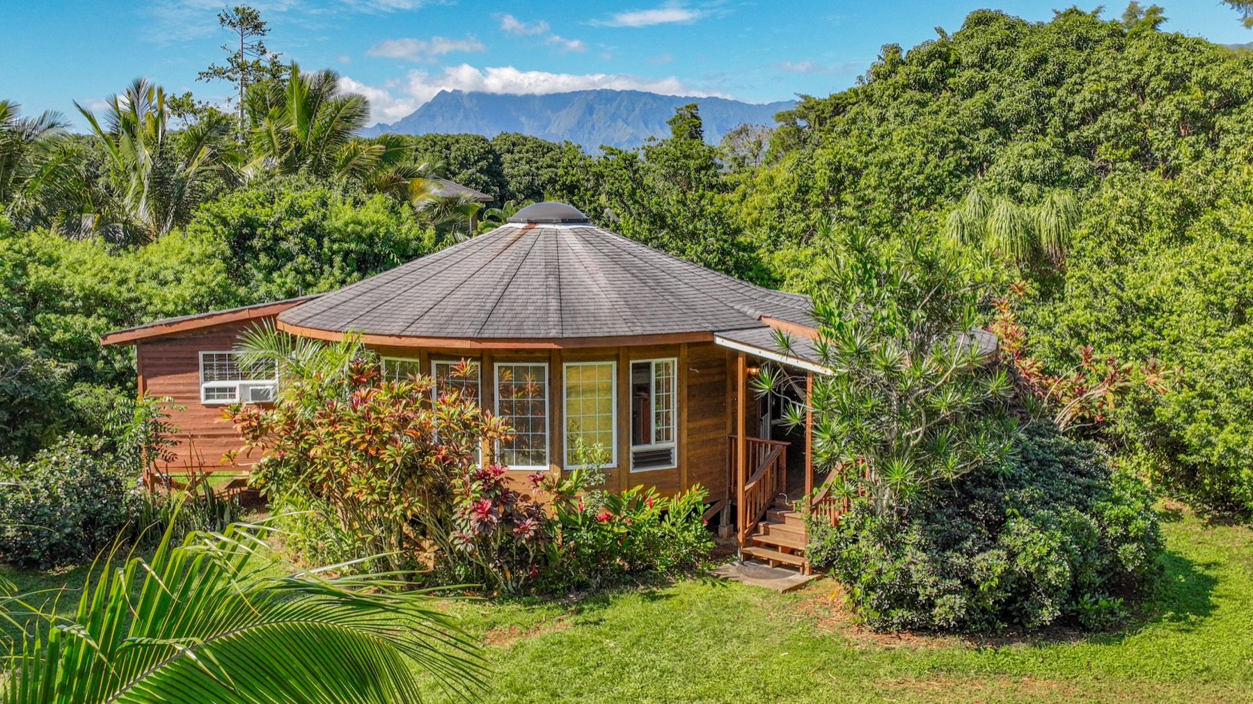 5715 Kaehulua Road, Unit 1 Kapaa, HI 96746 - Photo 3 of 23 a front view of house with yard and trees around