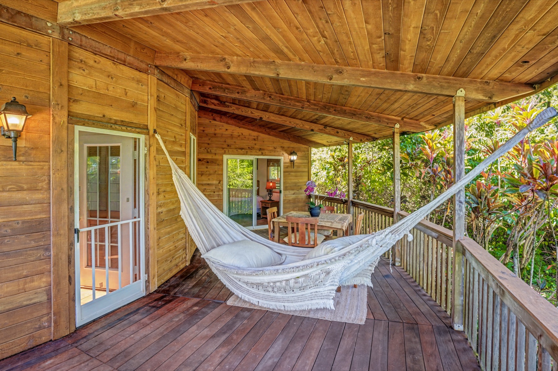 5715 Kaehulua Road, Unit 1 Kapaa, HI 96746 - Photo 6 of 23 a view of a chair and table on the deck
