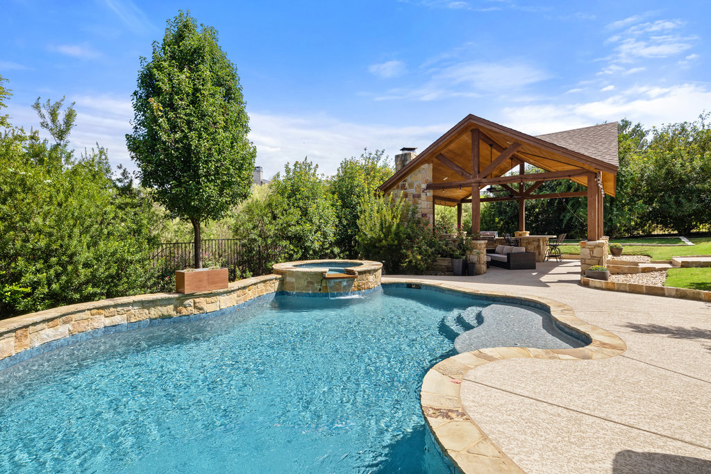 View of pool featuring a patio area, a pool with connected hot tub, and outdoor lounge area
