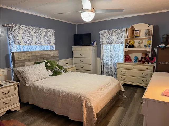 a bedroom with a bed and a television