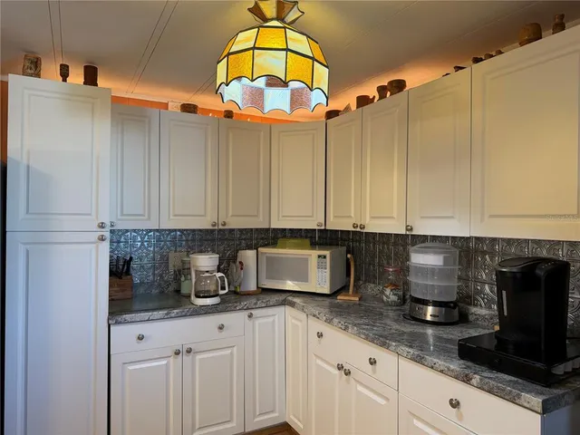a kitchen with stainless steel appliances a stove a sink and a microwave