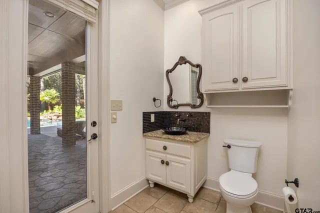 a bathroom with a toilet a sink and a mirror