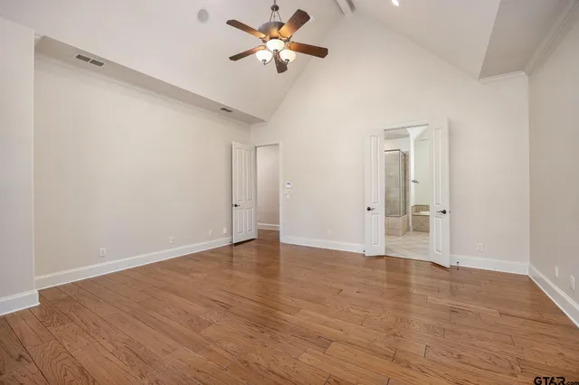 a view of an empty room with wooden floor