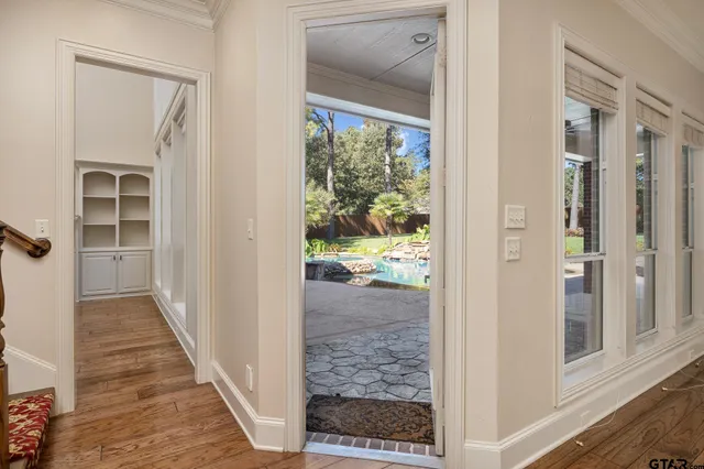 a view of a hallway with wooden floor and entryway