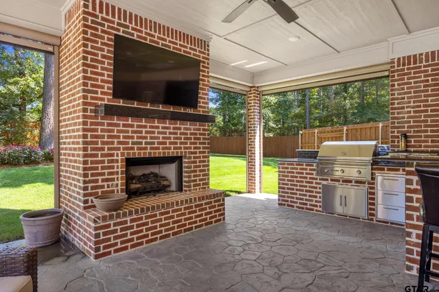 a living room with patio furniture and a fireplace