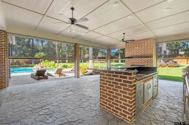 a kitchen with sink and view of living room