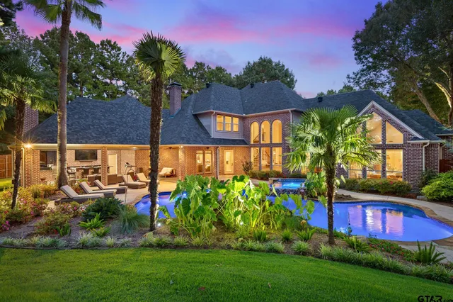 a view of a house with a yard and sitting area
