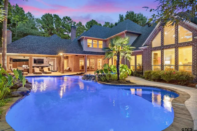 a view of house with swimming pool outdoor seating