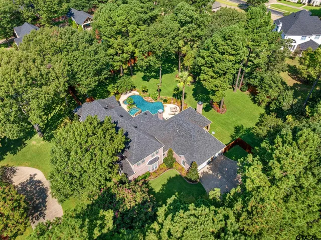 an aerial view of a house with a yard