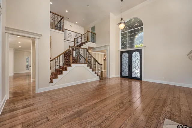 a view of entryway and hall with wooden floor