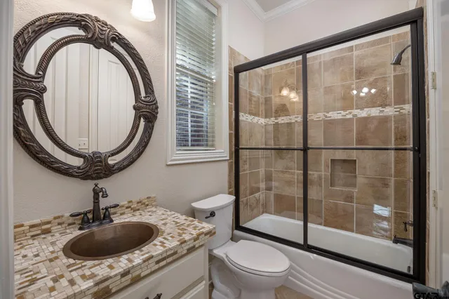 a bathroom with a sink a toilet and a mirror