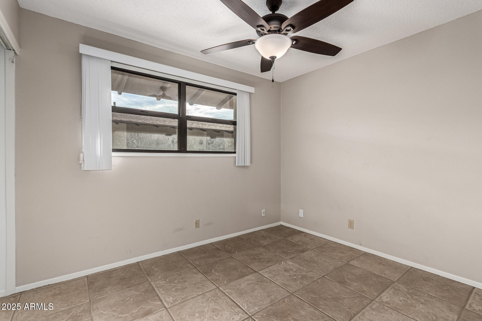 6721 East McDowell Road, Unit B314 Scottsdale, AZ 85257 - Photo 13 of 31 an empty room with windows and fan