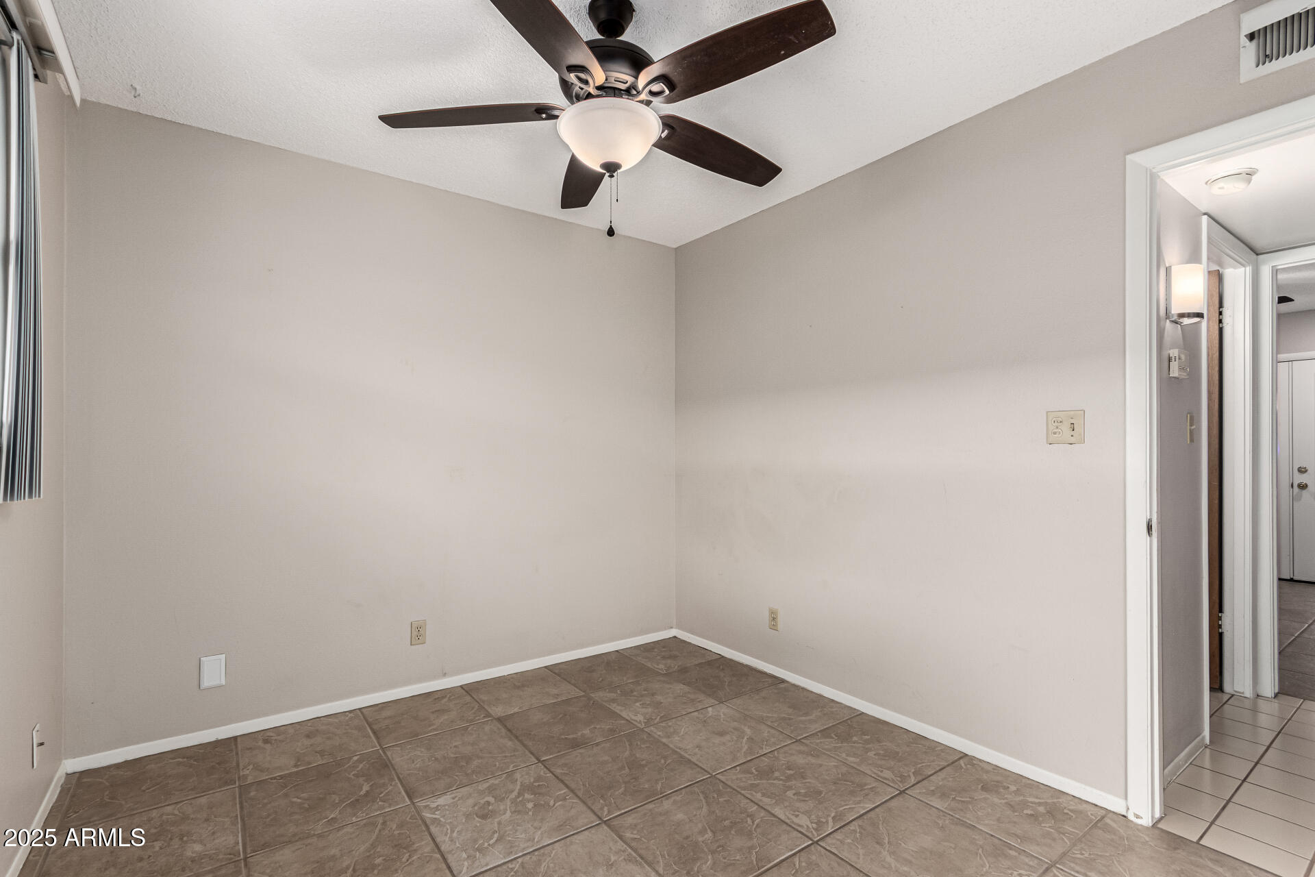 6721 East McDowell Road, Unit B314 Scottsdale, AZ 85257 - Photo 14 of 31 an empty room with a ceiling fan and carpet