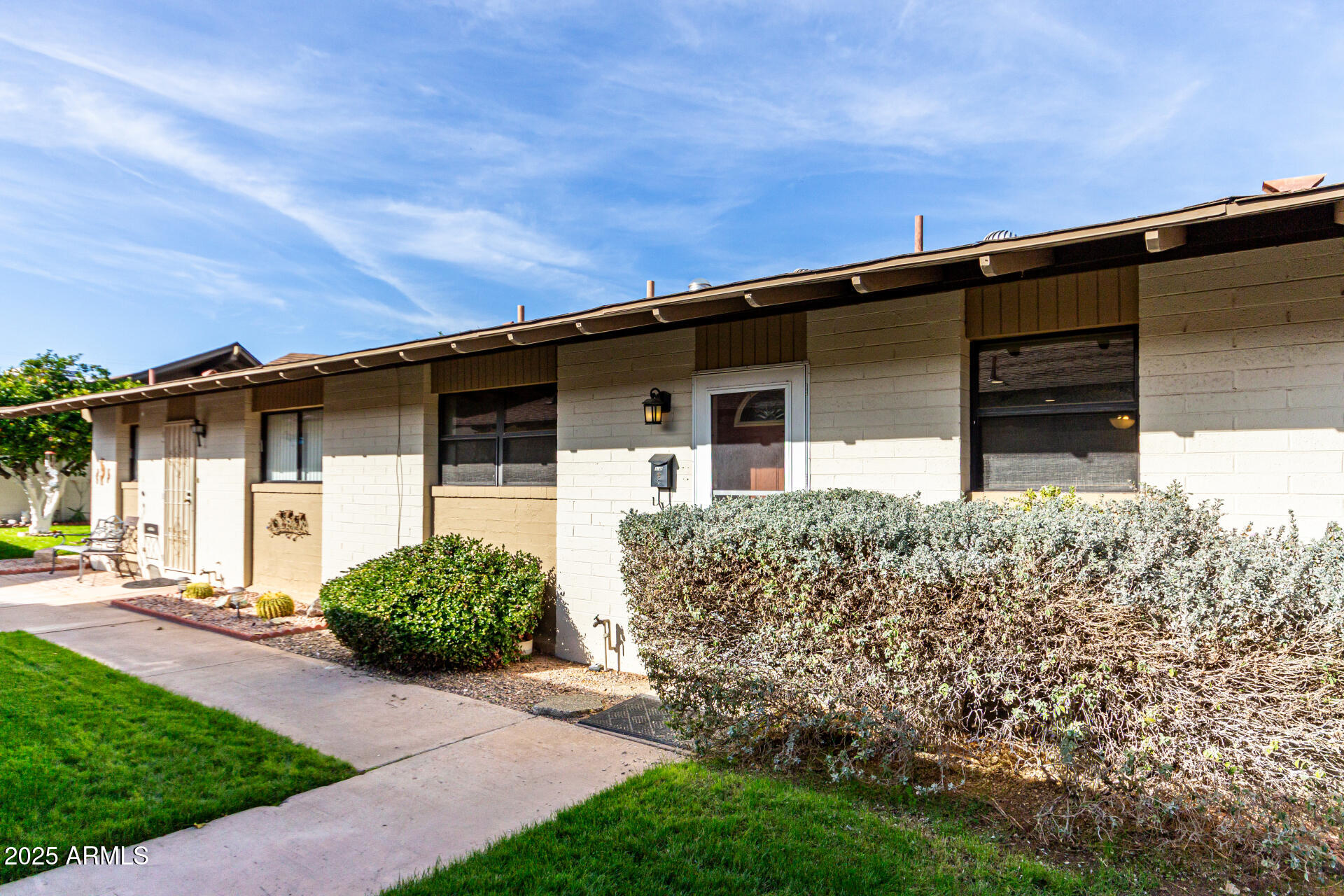 6721 East McDowell Road, Unit B314 Scottsdale, AZ 85257 - Photo 2 of 31 a front view of a house with garden