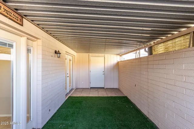 a view of swimming pool with chairs and table on the patio