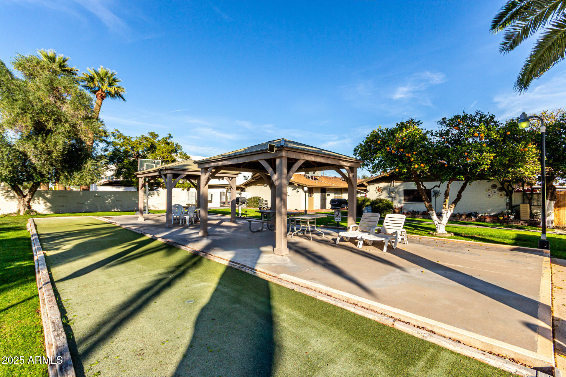 6721 East McDowell Road, Unit B314 Scottsdale, AZ 85257 - Photo 28 of 31 a view of swimming pool with chairs and table on the patio