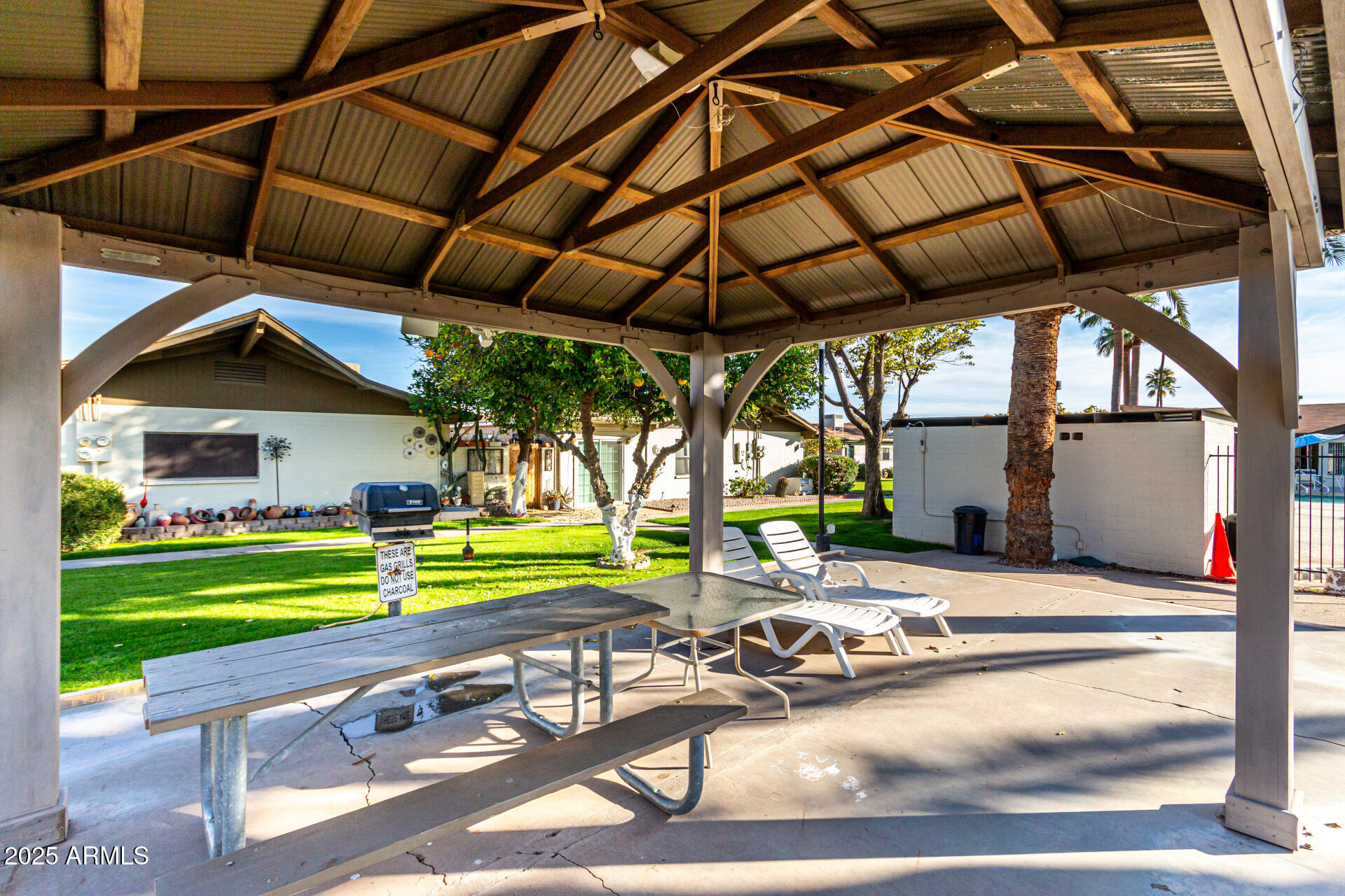 6721 East McDowell Road, Unit B314 Scottsdale, AZ 85257 - Photo 29 of 31 a view of a table and chairs under an umbrella