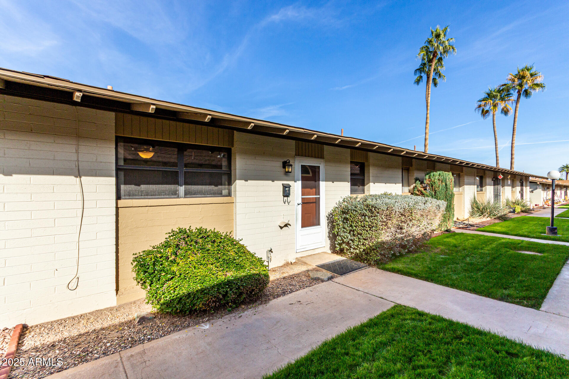6721 East McDowell Road, Unit B314 Scottsdale, AZ 85257 - Photo 3 of 31 a front view of a house with garden