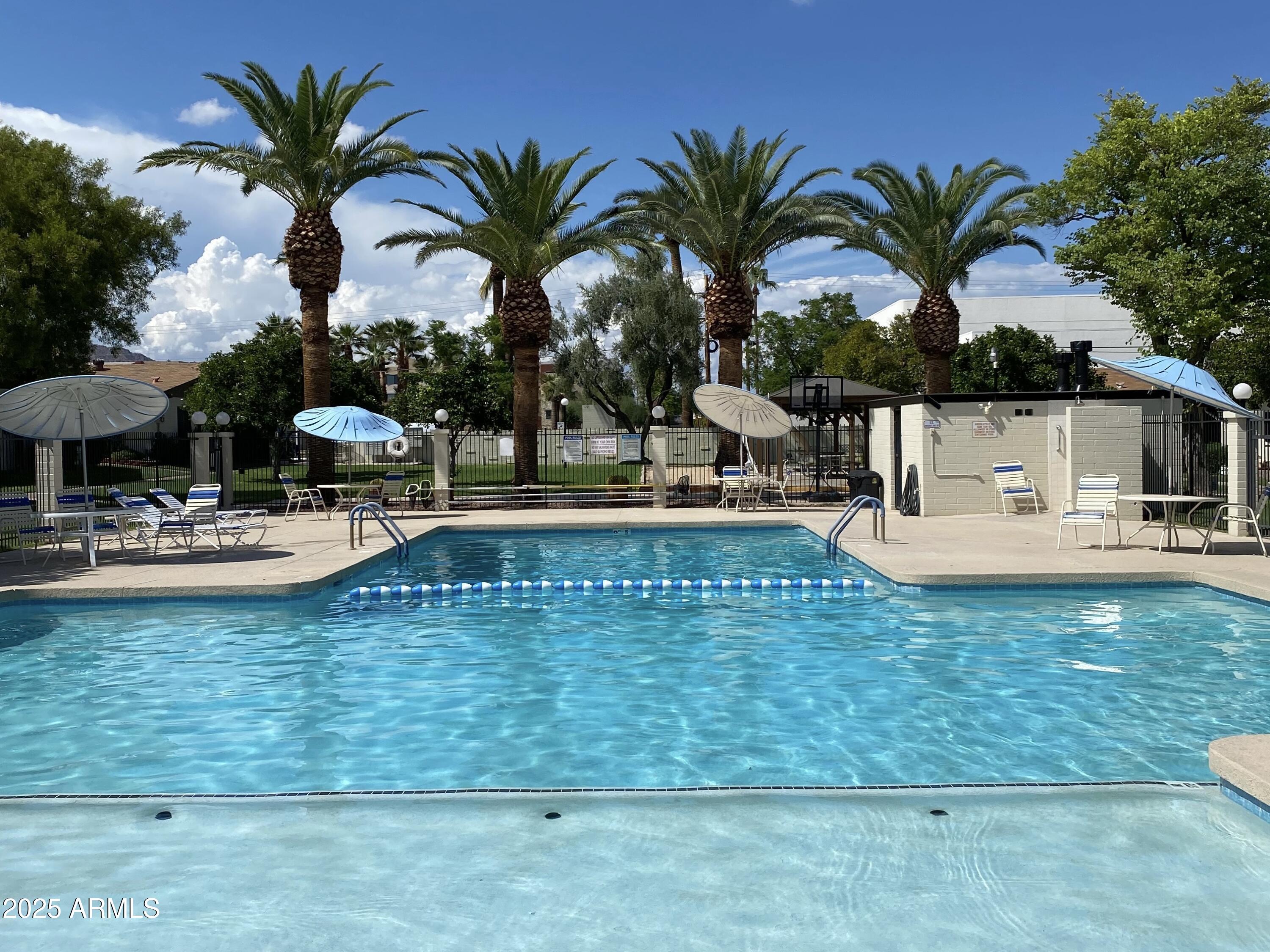 6721 East McDowell Road, Unit B314 Scottsdale, AZ 85257 - Photo 31 of 31 a view of a swimming pool with a table and chairs