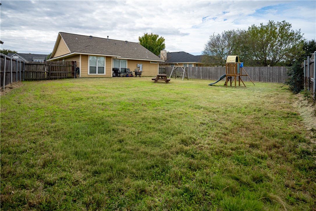 904 Crested Point Drive College Station, TX 77845 - Photo 11 of 11 Fenced backyard featuring a playground and a patio