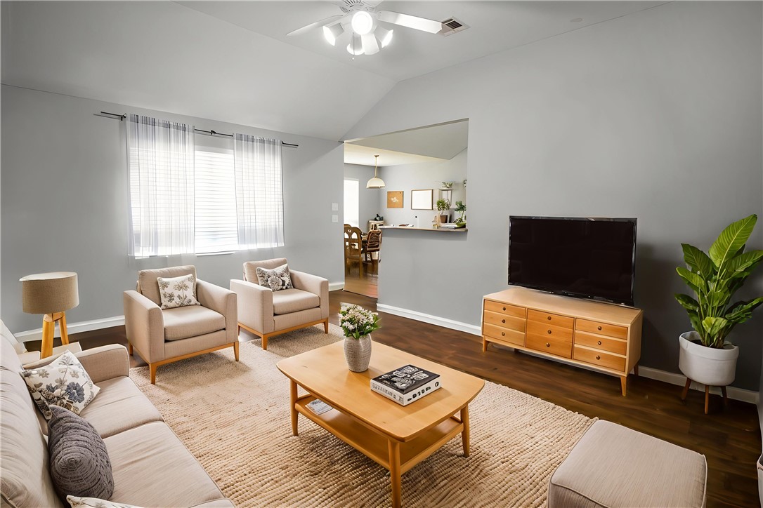 904 Crested Point Drive College Station, TX 77845 - Photo 2 of 11 Living area featuring ceiling fan, vaulted ceiling, and wood finished floors