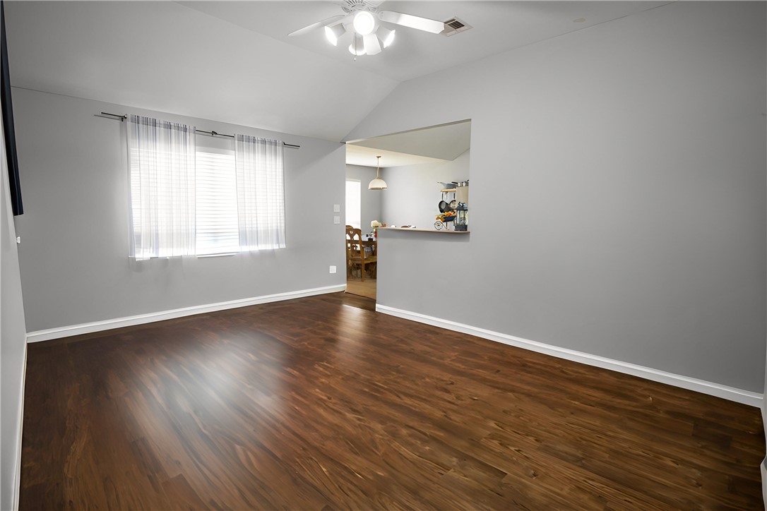 904 Crested Point Drive College Station, TX 77845 - Photo 3 of 11 Living room featuring dark wood-style floors, lofted ceiling, and a ceiling fan