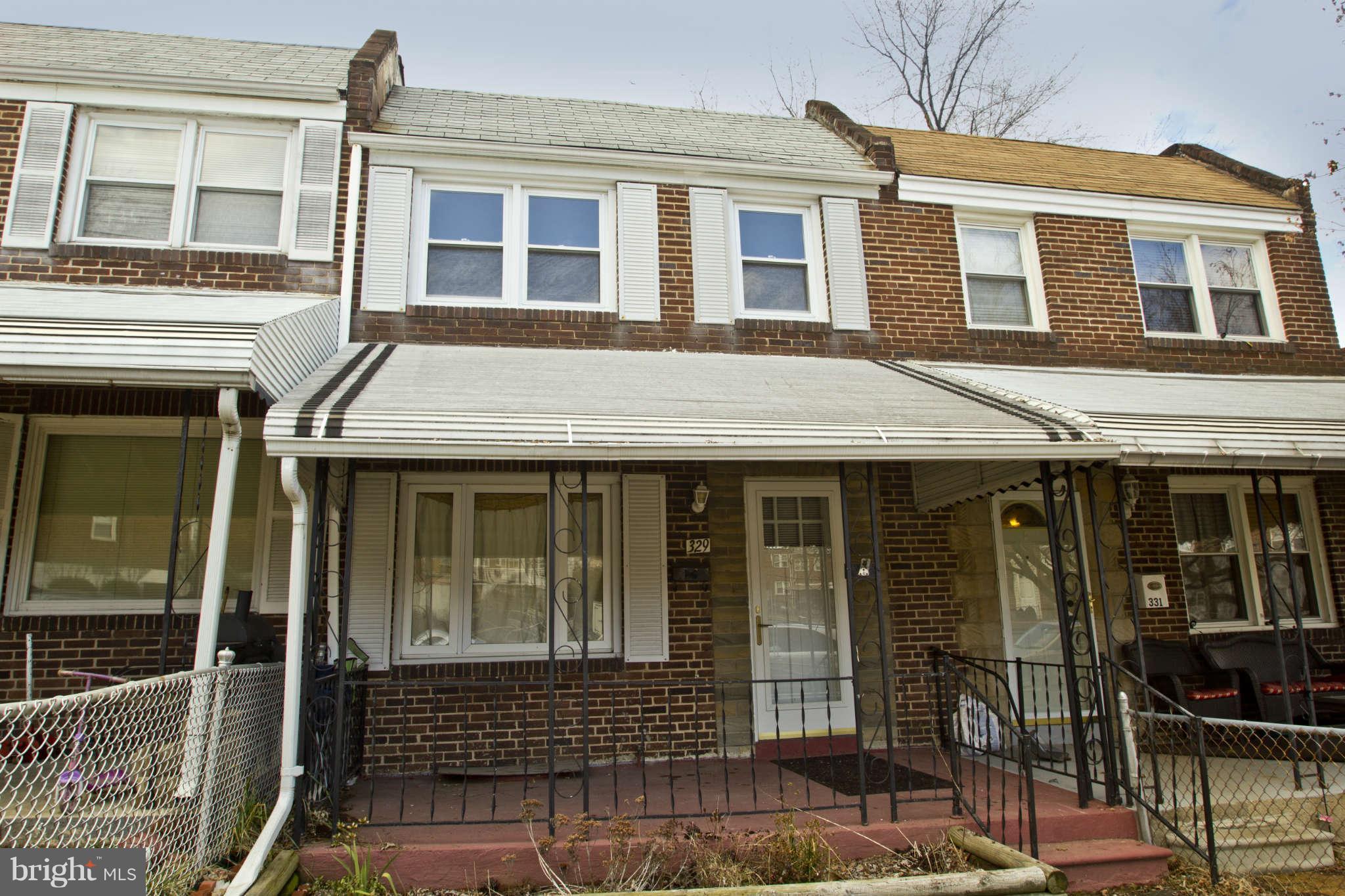 329 Grove Park Road Baltimore, MD 21225 - Photo 1 of 19 a front view of a house with glass windows
