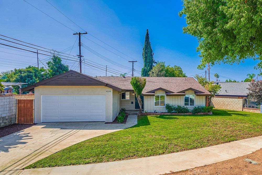 4238 Royce Street Riverside, CA 92503 - Photo 1 of 1 a front view of a house with garden