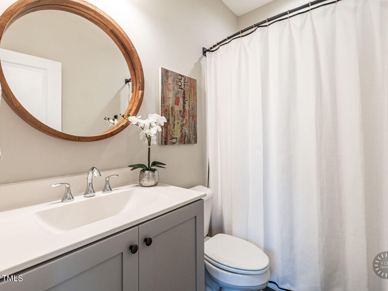 806 Malta Way Durham, NC 27703 - Photo 25 of 37 a bathroom with a sink a mirror and a toilet