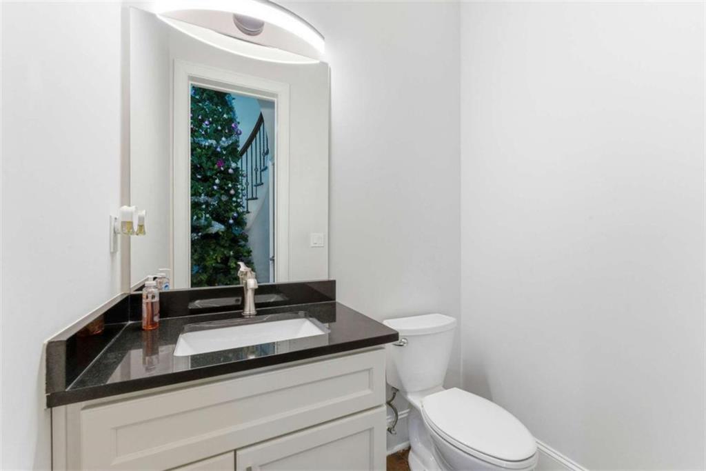 1616 Palmilla Way Southwest Stockbridge, GA 30281 - Photo 12 of 50 a bathroom with a granite countertop sink a toilet and a mirror
