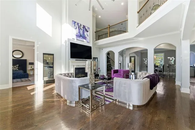 a kitchen with stove a refrigerator and a sink with wooden floor