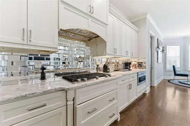 a kitchen with stainless steel appliances a refrigerator sink and cabinets