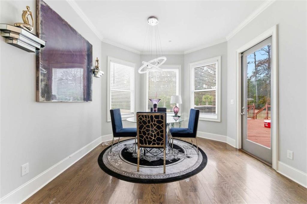1616 Palmilla Way Southwest Stockbridge, GA 30281 - Photo 19 of 50 a dining room with furniture a window and wooden floor