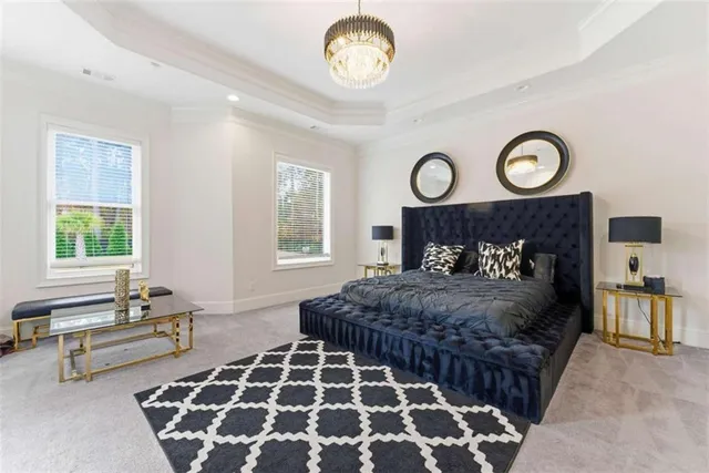 a bedroom with a bed and a flat tv screen on the dresser