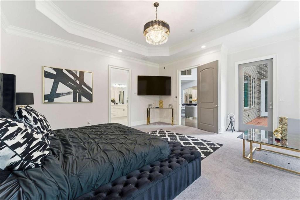 1616 Palmilla Way Southwest Stockbridge, GA 30281 - Photo 21 of 50 a bedroom with a bed and a flat tv screen on the dresser