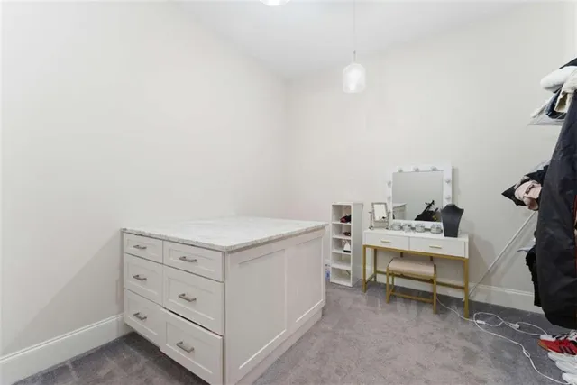 a kitchen with washing machine and cabinets