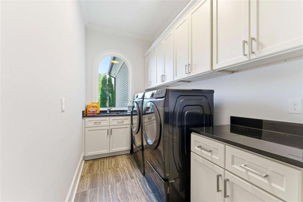 1616 Palmilla Way Southwest Stockbridge, GA 30281 - Photo 25 of 50 a kitchen with washing machine and cabinets
