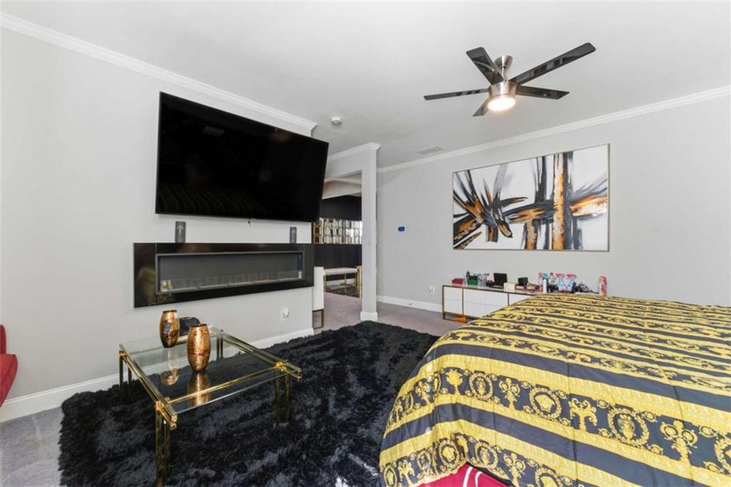 1616 Palmilla Way Southwest Stockbridge, GA 30281 - Photo 33 of 50 a bedroom with a bed and a flat screen tv