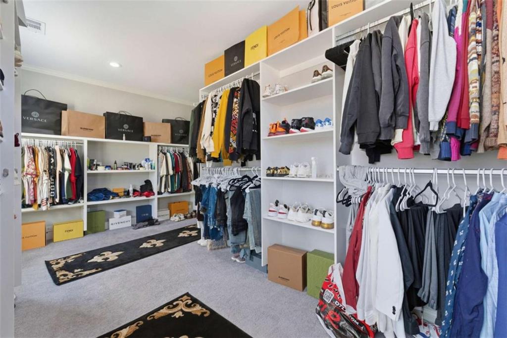 1616 Palmilla Way Southwest Stockbridge, GA 30281 - Photo 35 of 50 a view of walk in closet with clothes and shoes