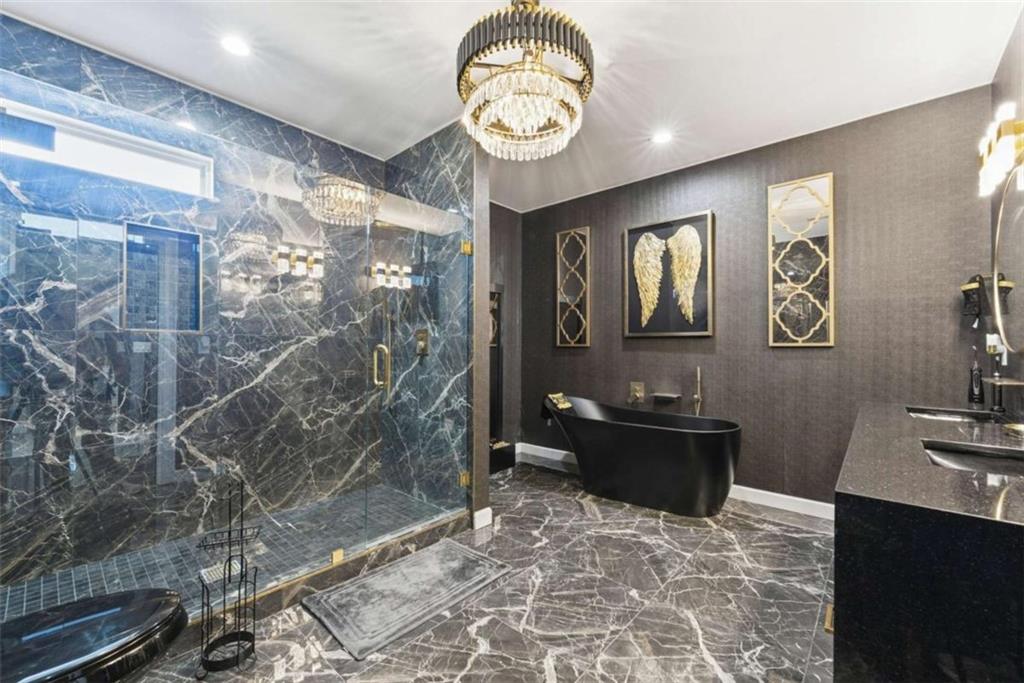 1616 Palmilla Way Southwest Stockbridge, GA 30281 - Photo 36 of 50 a view of a hallway with wooden floor and a chandelier