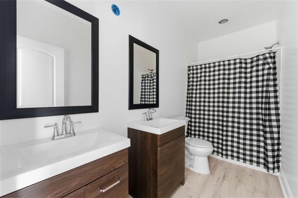 1616 Palmilla Way Southwest Stockbridge, GA 30281 - Photo 38 of 50 a bathroom with a sink vanity mirror and toilet