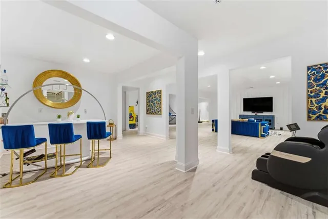 a view of a workspace with furniture and wooden floor