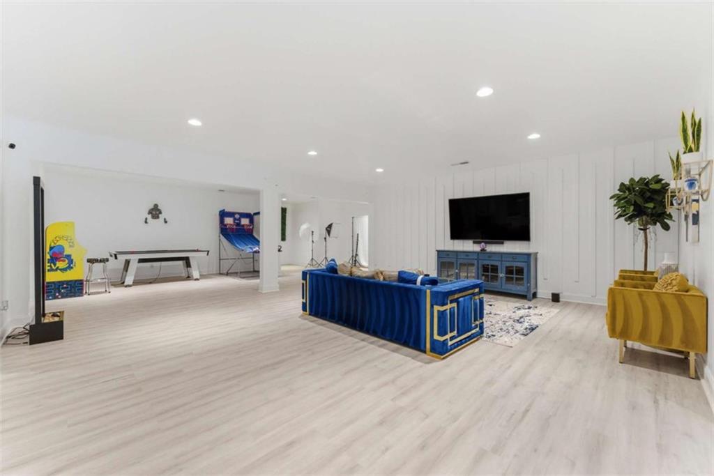 1616 Palmilla Way Southwest Stockbridge, GA 30281 - Photo 41 of 50 a living room with furniture and a flat screen tv