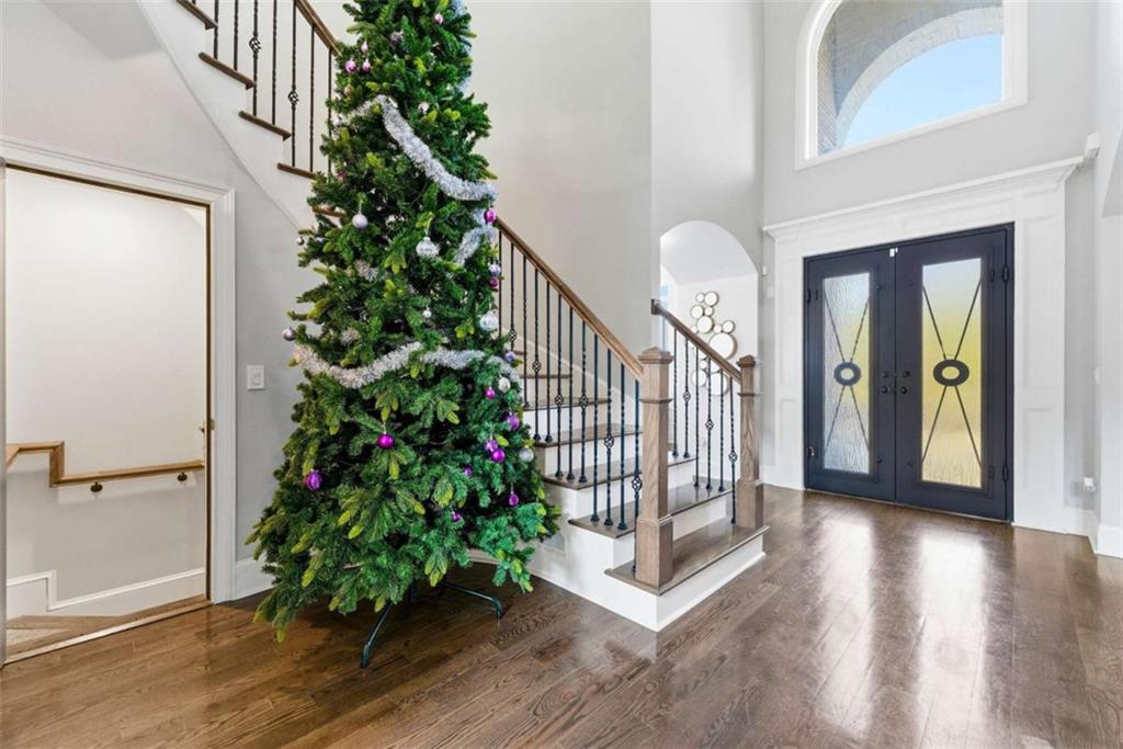 1616 Palmilla Way Southwest Stockbridge, GA 30281 - Photo 7 of 50 a view of a hallway to a house with wooden floor and stairs