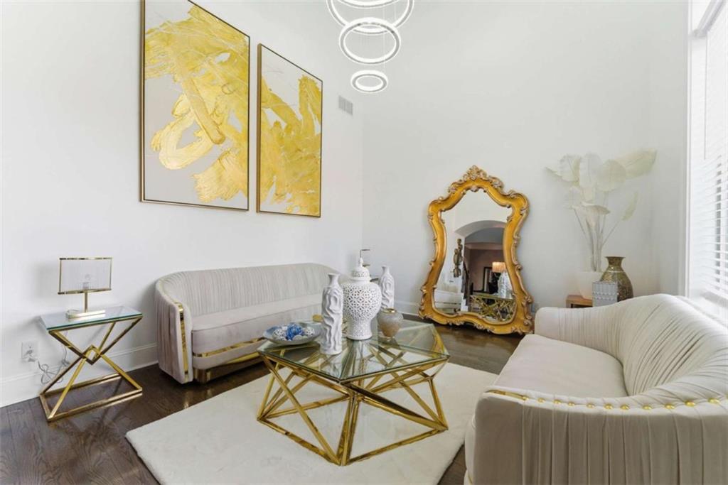 1616 Palmilla Way Southwest Stockbridge, GA 30281 - Photo 8 of 50 a living room with furniture a flat screen tv and a table