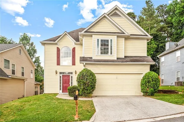 a front view of a house with garden