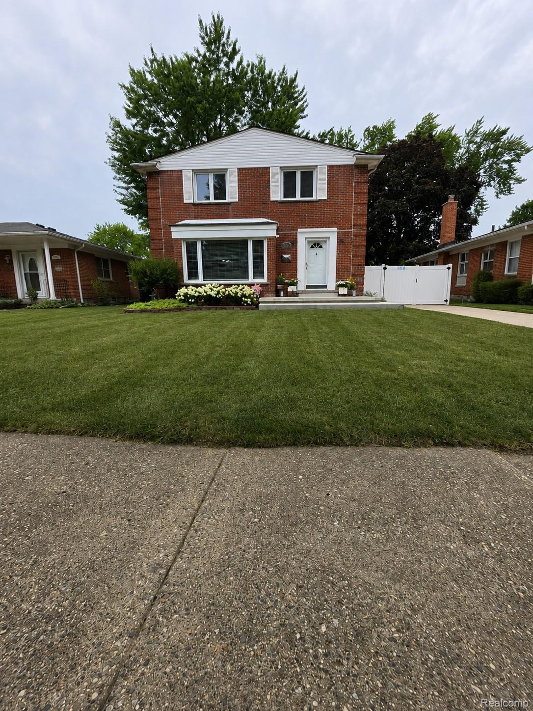 31159 Kelly Road Fraser, MI 48026 - Photo 1 of 34 Brick facade residence with white siding accents and a contrasting white front door