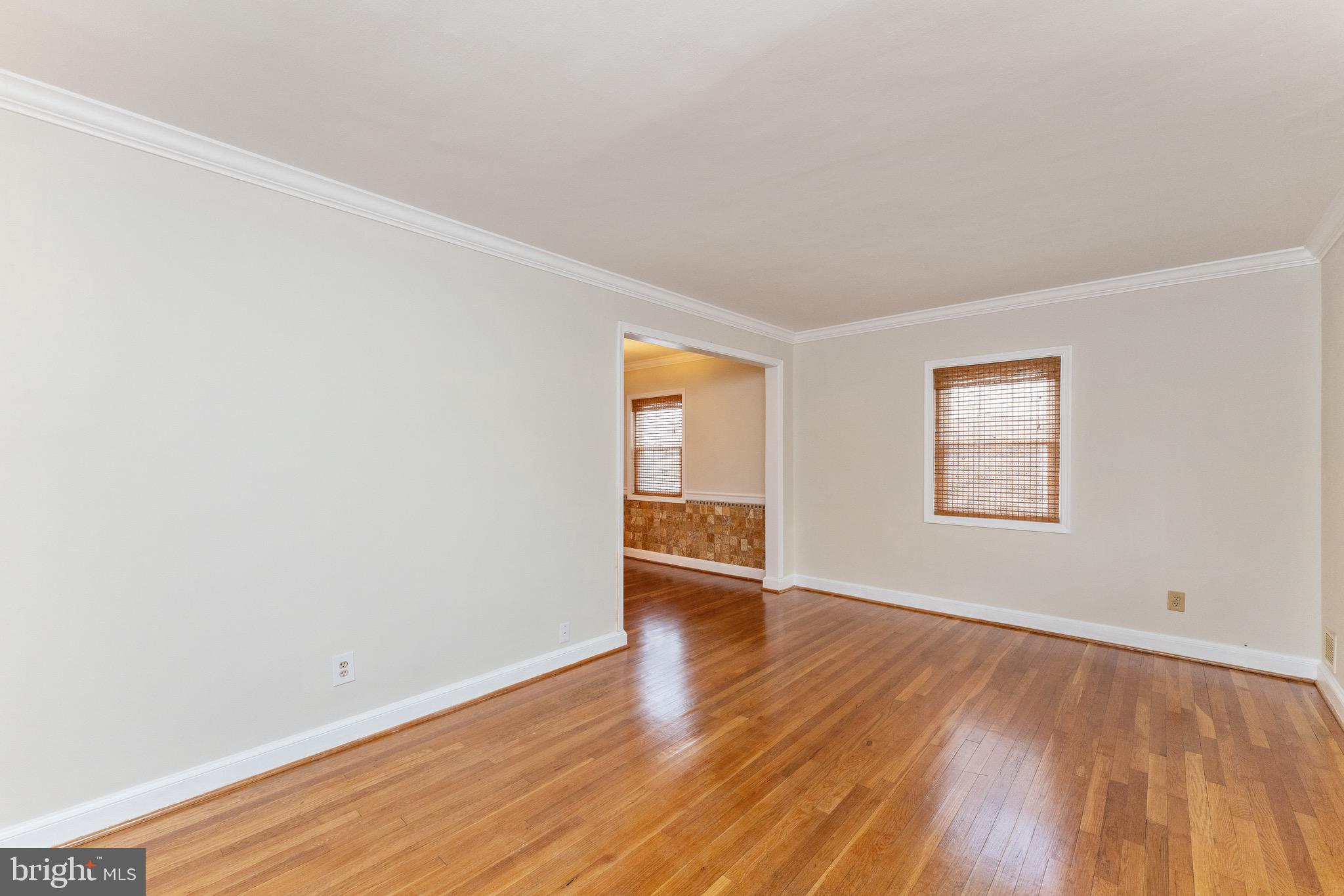 1609 Brisbane Street Silver Spring, MD 20902 - Photo 16 of 25 an empty room with wooden floor and windows