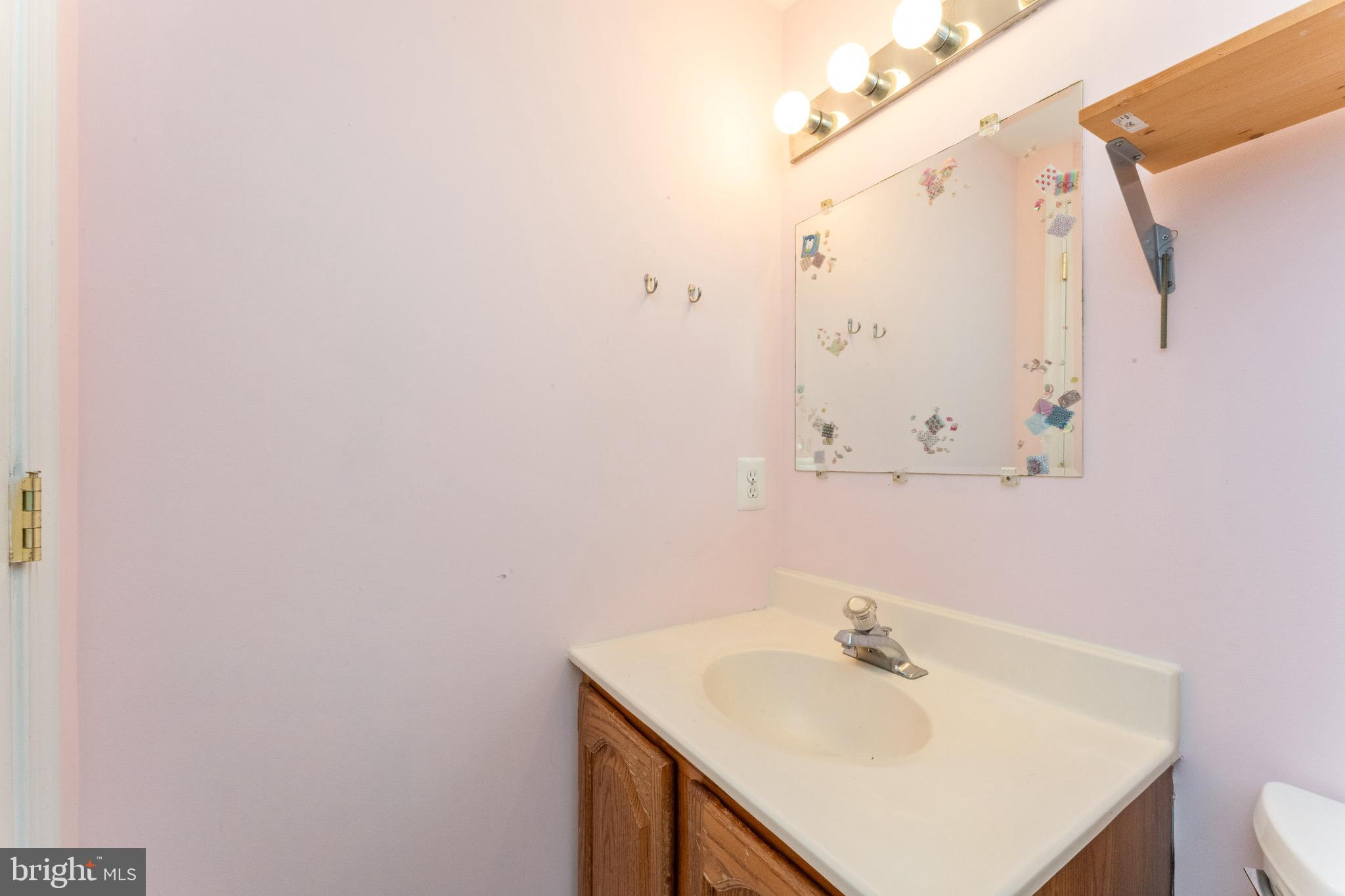 1609 Brisbane Street Silver Spring, MD 20902 - Photo 25 of 25 a bathroom with a sink and a mirror