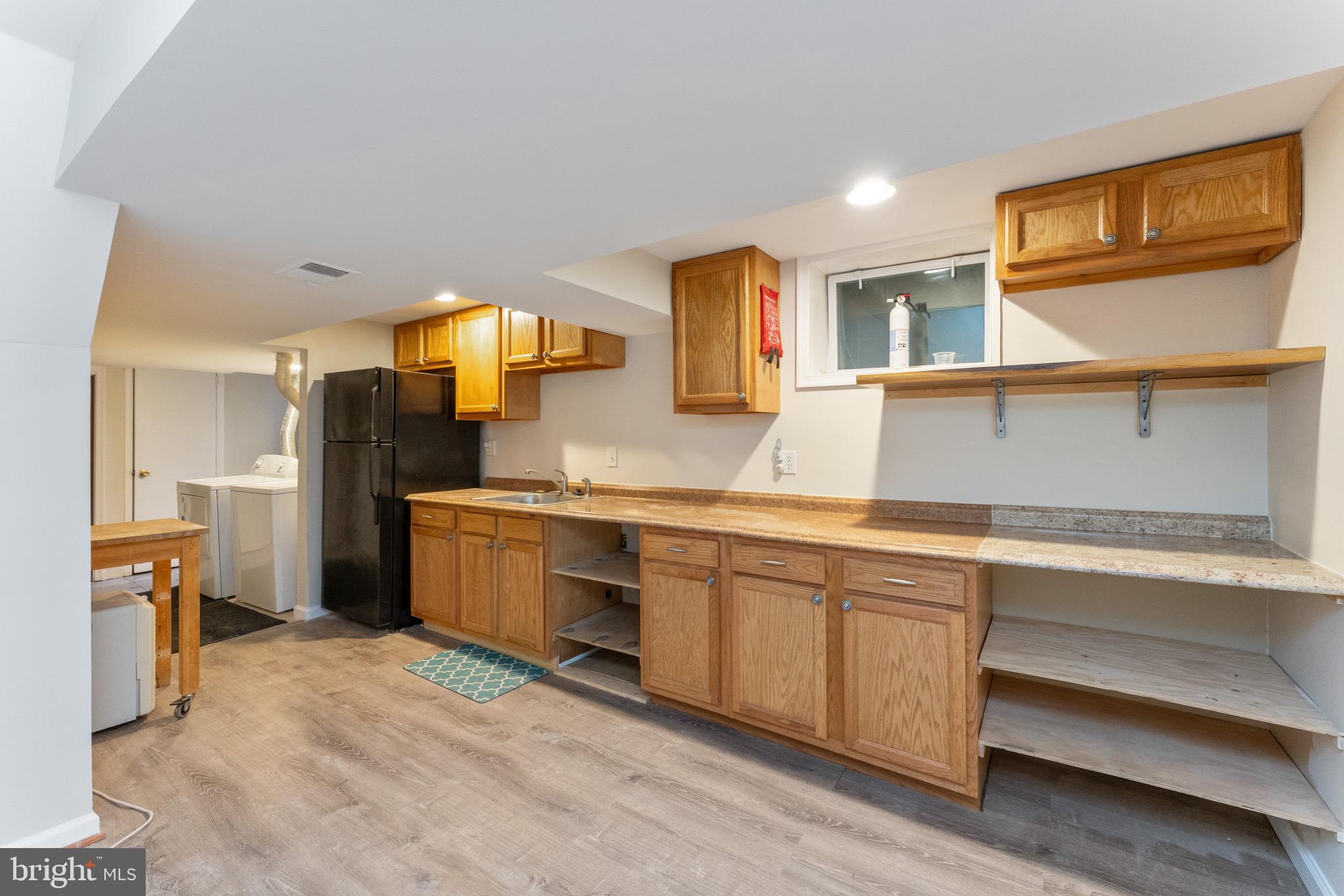 1609 Brisbane Street Silver Spring, MD 20902 - Photo 4 of 25 a kitchen with a sink cabinets and appliances
